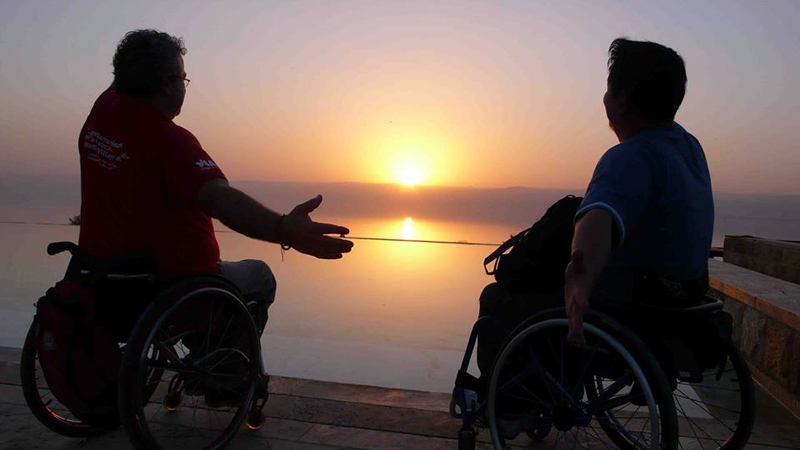 Jordan Dead Sea sunset with visitors and wheelchairs
