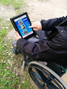 Photo of wheelchair user with PREDIF's app. 