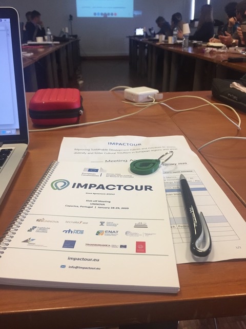 IMPACTOUR image of notebook with pen in meeting room 