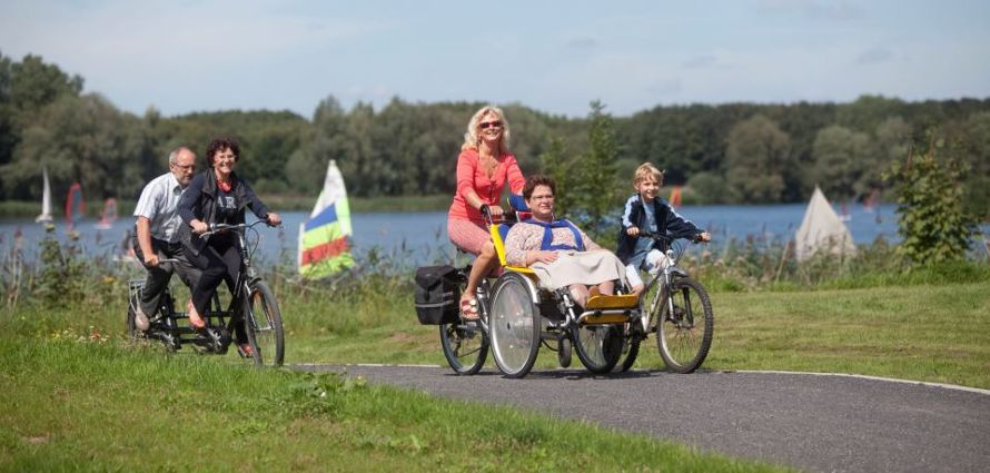 Friends enjoying a cycling tour together with a tandem and an adapted wheelchair bike. Photo: VisitFlanders