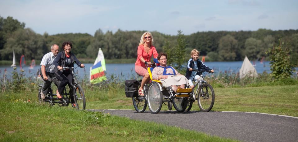 Friends enjoying a cycling tour together with a tandem and an adapted wheelchair bike. Photo: VisitFlanders