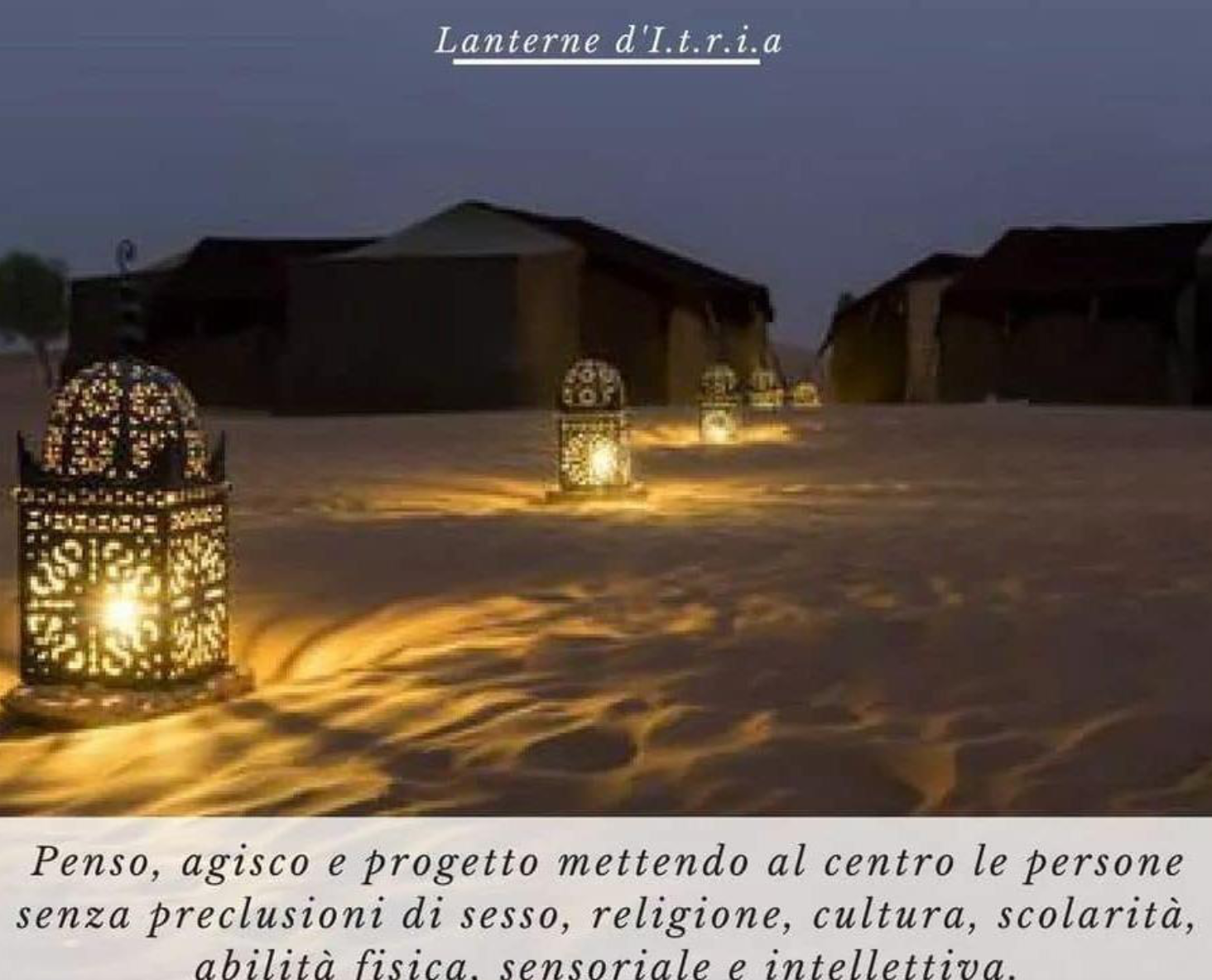Image of lanterns with candles across an expanse of sand 