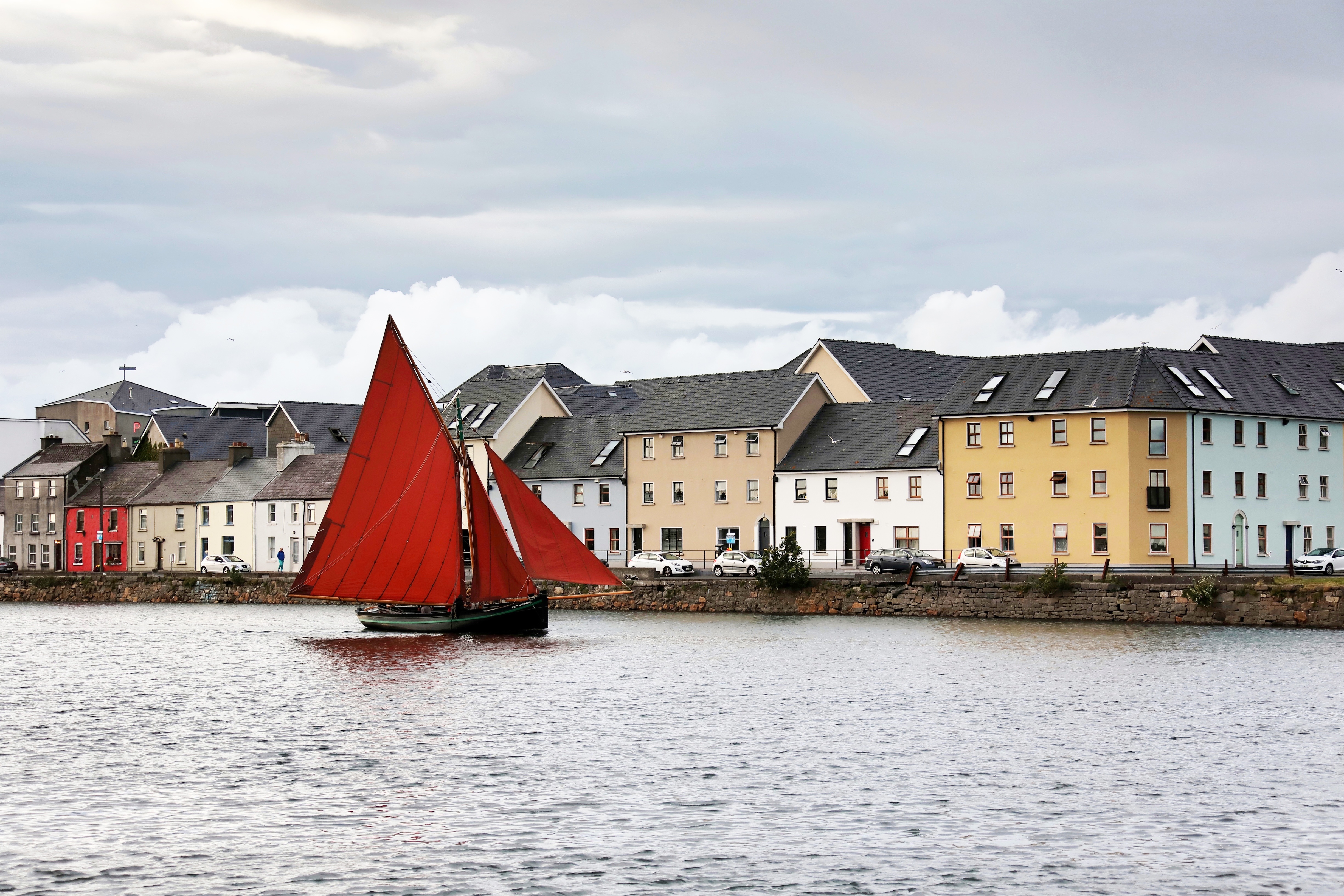 Image of a traditional, gaff-rigged Galway Hooker sailing boat, a common sight in Galway Bay.  